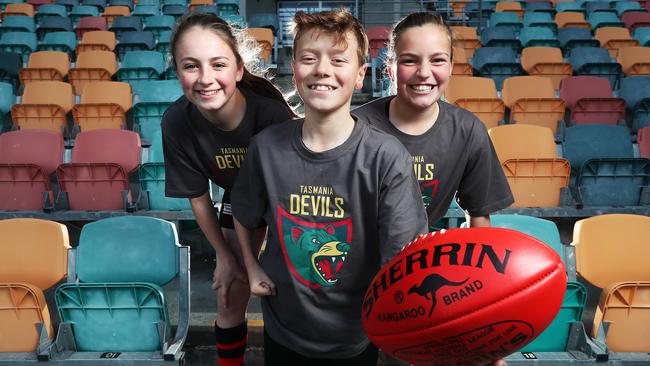 Junior players from Lauderdale Football Club, from left, Gracie Bradburn, 12, Ben Williams, 12, and Sophie Mead, 11, wearing T-shirts with the new logo. Picture: NIKKI DAVIS-JONES