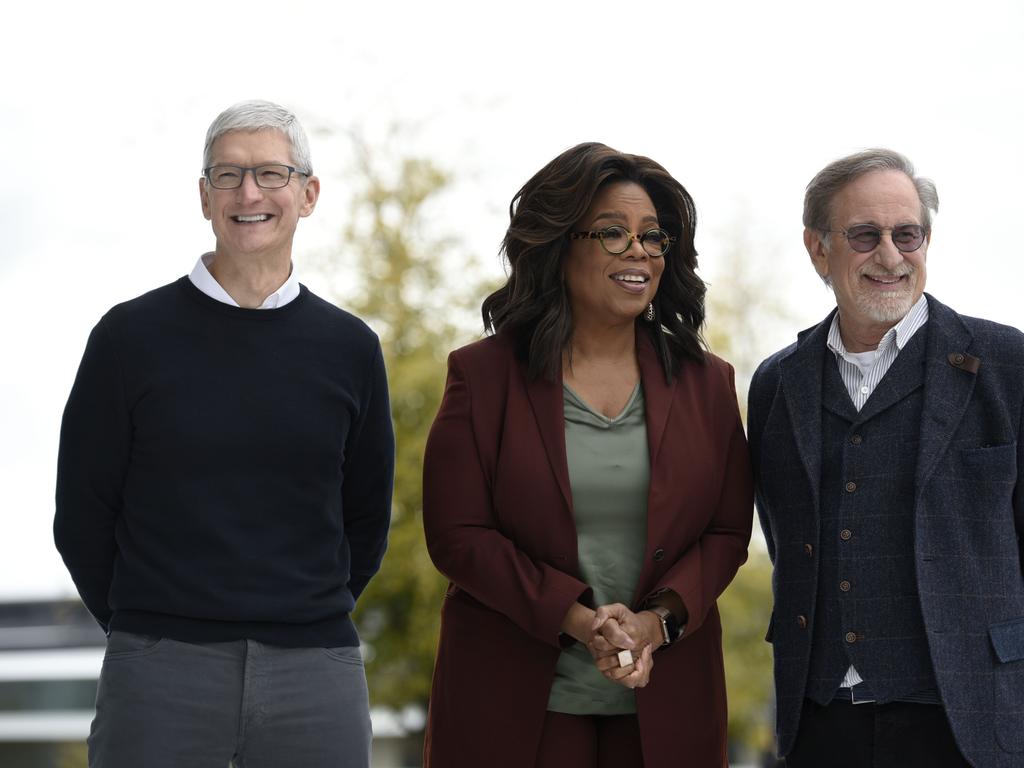 Oprah Winfrey with Steven Spielberg and Tim Cook, will work on a variety of projects with Apple, including a documentary series with Prince Harry. Picture: Getty Images/AFP 