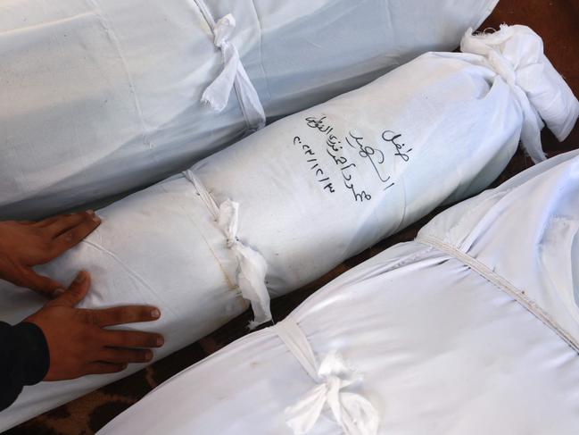 A Palestinian man mourns at al-Najjar hospital near the shrouded bodies of relatives killed in Israeli bombing on Rafah in the southern Gaza Strip. Picture: AFP