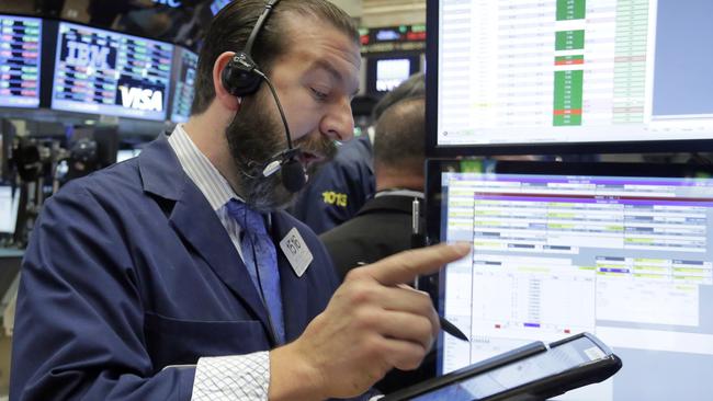 Trader Greg Mulligan works on the floor of the New York Stock Exchange, Friday, Oct. 23, 2015. Technology shares are surging in early trading after several big-name companies reported big earnings gains. (AP Photo/Richard Drew)