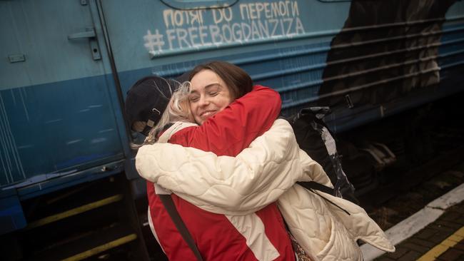 Liudmyla (left) hugs her granddaughter Ania who arrived on the first train to arrive back to Kherson Railway station on November 19. Picture: Chris McGrath/Getty Images