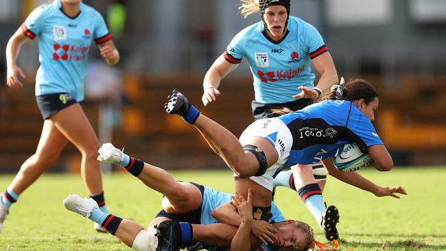 Tamika Jones of the Force is tackled by Georgina Friedrichs of the Waratahs last season.