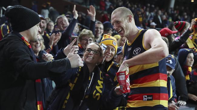 Sam Jacobs enjoys a treat with fans at the end of the game. Picture Sarah Reed