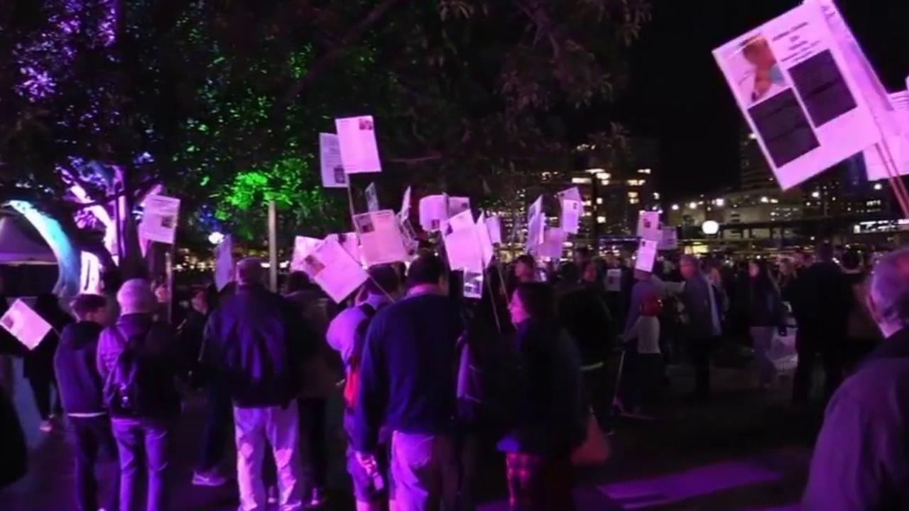 Dozens marched through the busy harbourside precinct with placards. Picture: Facebook