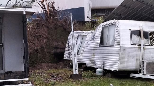 A caravan destroyed in a backyard.