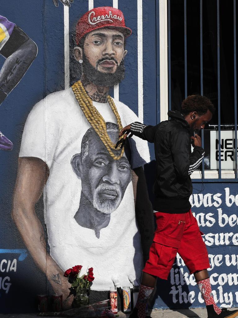 A man touches a mural depicting slain rapper Nipsey Hussle. Picture: AP