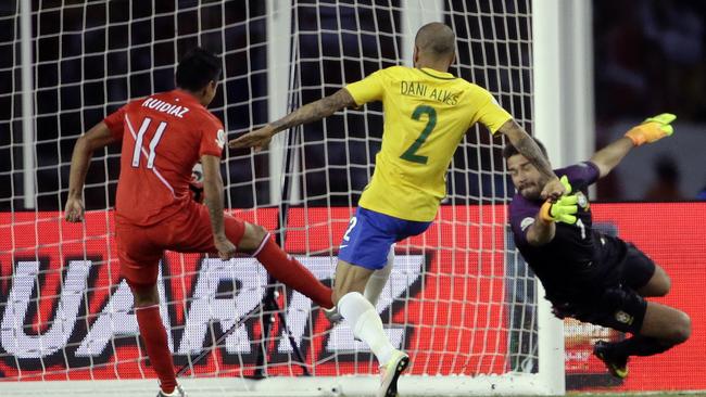Peru's Raul Ruidiaz (11) scores a goal past Brazil’s goalkeeper Alisson.
