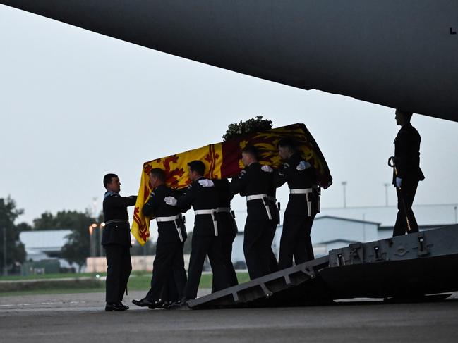 Pallbearers from the Queen's Colour Squadron carry the coffin from the C-17 at the Royal Air Force Northolt air base. Picture: Images