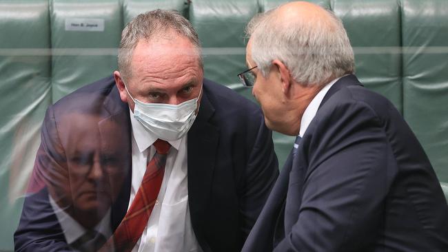 Barnaby Joyce and Scott Morrison confer in question time on Wednesday, under the watchful gaze of Anthony Albanese. Picture: Gary Ramage