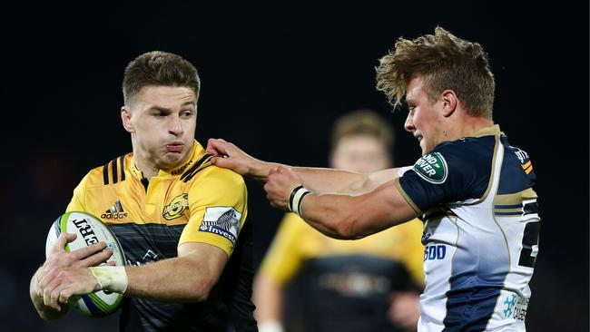 Beauden Barrett of the Hurricanes fends Jordan Jackson-Hope of the Brumbies.