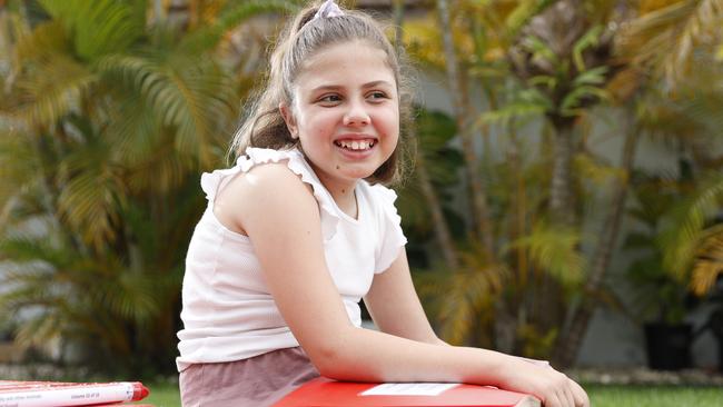 Bookworm Eva Garcia, 10, who contracted viral encephalitis just after her first birthday, volunteers at Braille House. Picture: Lachie Millard