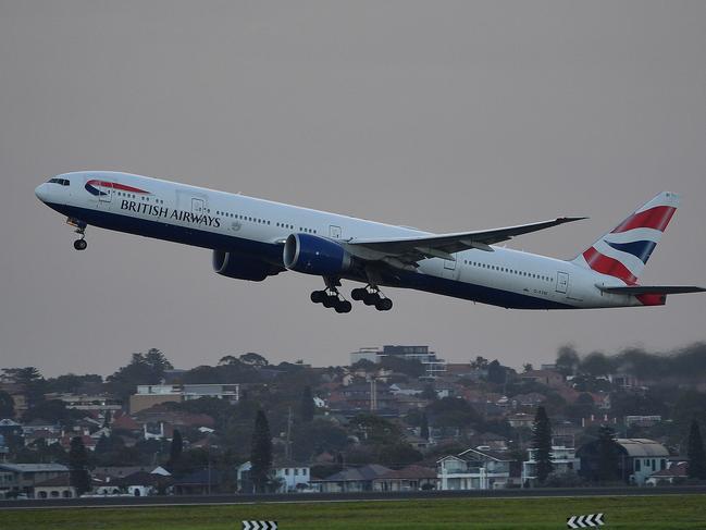 A British Airways flight takes off from Sydney International Airport in Sydney on March 27, 2020. - The Australian military will help enforce the quarantine of travellers returning to the country, with the prime minister unveiling strict new measures and door-to-door checks to rein in the spread of COVID-19. (Photo by Saeed KHAN / AFP)