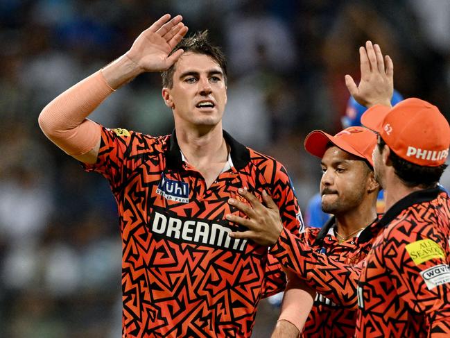 Sunrisers Hyderabad's captain Pat Cummins (L) celebrates with teammates after taking the wicket of Mumbai Indians' Rohit Sharma (not pictured) during the Indian Premier League (IPL) Twenty20 cricket match between Mumbai Indians and Sunrisers Hyderabad at the Wankhede Stadium in Mumbai on May 6, 2024. (Photo by Punit PARANJPE / AFP) / -- IMAGE RESTRICTED TO EDITORIAL USE - STRICTLY NO COMMERCIAL USE --