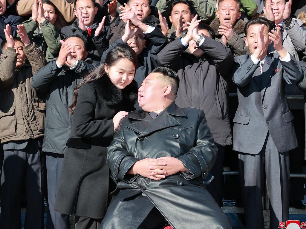 The pair posed with scientists and engineers from a defence science research institute, and workers at a munitions factory, who contributed to the test-firing of the ICBM. Picture: KCNA VIA KNS / AFP.