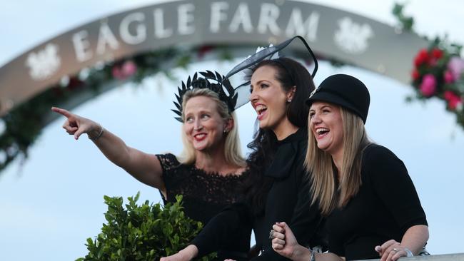 Tanya Venzke, Miranda Witt, and Louise Morrison lap up the action at Eagle Farm. Picture: Tara Croser.