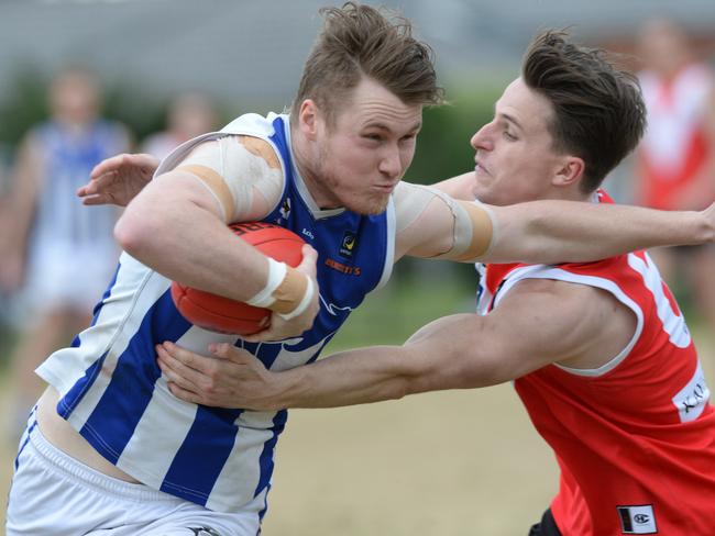 Langwarrin forward Jesse Murrphy fends off Red Hill’s James Fletcher. Picture: Chris Eastman