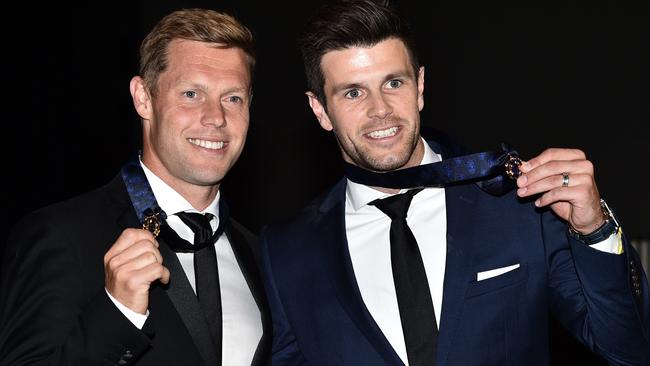 Trent Cotchin and Sam Mitchell poses for photos with their retrospective 2012 Brownlow medals at a ceremony in Melbourne in Melbourne, Tuesday, Dec. 13, 2016. (AAP Image/Julian Smith) NO ARCHIVING, EDITORIAL USE ONLY