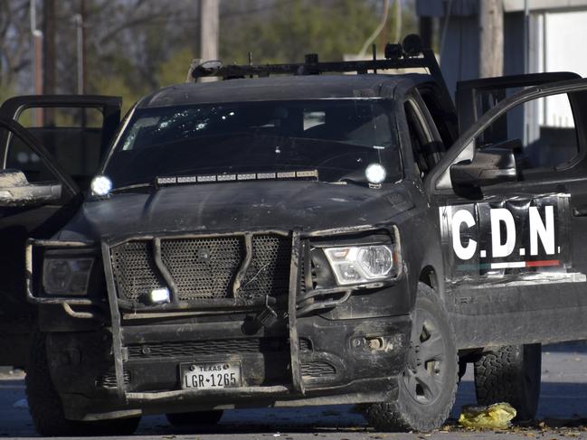 A damaged pick up marked with the initials C.D.N., that in Spanish stand for Cartel of the Northeast, is on the streets after a gunbattle between Mexican security forces and suspected cartel gunmen. Picture: AP