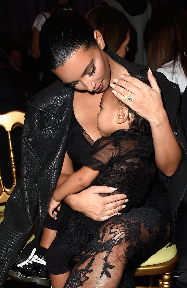 Kim Kardashian and North West attend the Givenchy show as part of Paris Fashion Week Womenswear Spring/Summer 2015. Photo by Pascal Le Segretain.