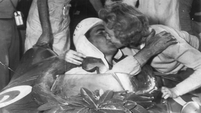 Jack Brabham receives a kiss from his wife after winning the 1955 Australian Grand Prix.