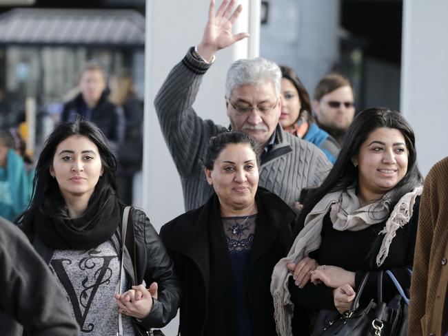 Iman Alknfushe (centre) exits JFK with her daughters Elaf, right, and Anfal Hussain in New York on Sunday. Attorneys advocating on her behalf said Alknfushe was coming from Iraq and had been detained at the airport for more than 30 hours. Picture: Seth Wenig/AP