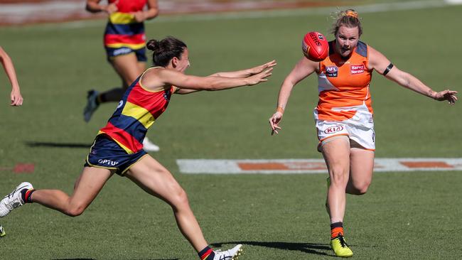 ADELAIDE, AUSTRALIA – MARCH 15: Tait Mackrill of the Giants kicks the ball past Angela Foley of the Crows during the 2020 AFLW Round 06 match between the Adelaide Crows and the GWS Giants at Hisense Stadium on March 15, 2020 in Adelaide, Australia. (Photo by Matt Turner/AFL Photos via Getty Images)