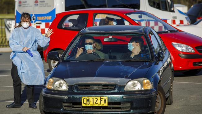 Lesley Eade, left, and son Harrison Millett 19, leave the COVID-19 testing facility in Batemans Bay, NSW. Picture: Sean Davey