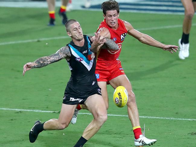 GOLD COAST, AUSTRALIA - MARCH 21: Hamish Hartlett of the Power and David Swallow of the Suns compete during the round 1 AFL match between the Gold Coast Suns and the Port Adelaide Power at Metricon Stadium on March 21, 2020 in Gold Coast, Australia. (Photo by Jono Searle/AFL Photos/Getty Images)