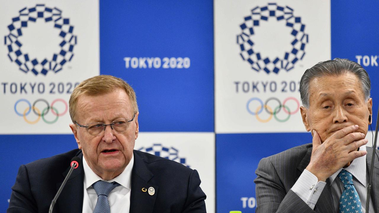 Head of the Australia Olympic Committee John Coates (L) has announced a small pay cut.