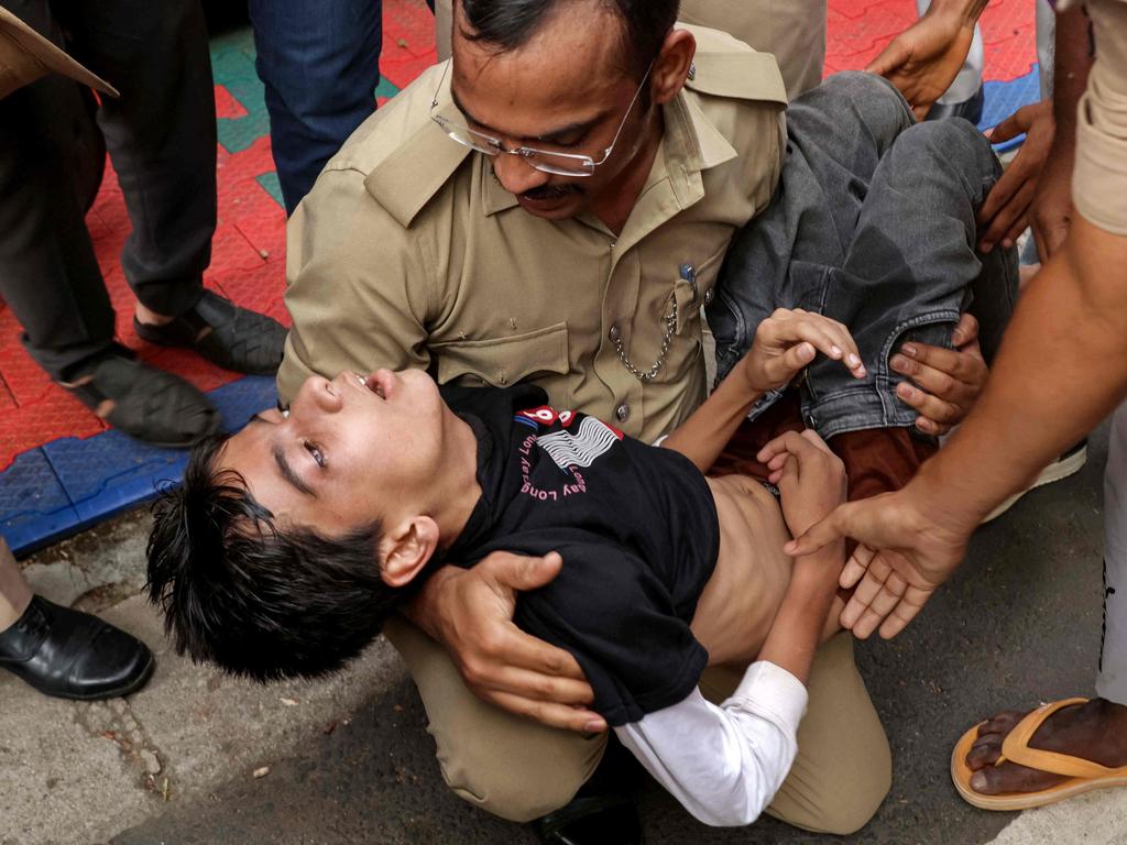 Police personnel assist a stampede victim. Picture: AFP