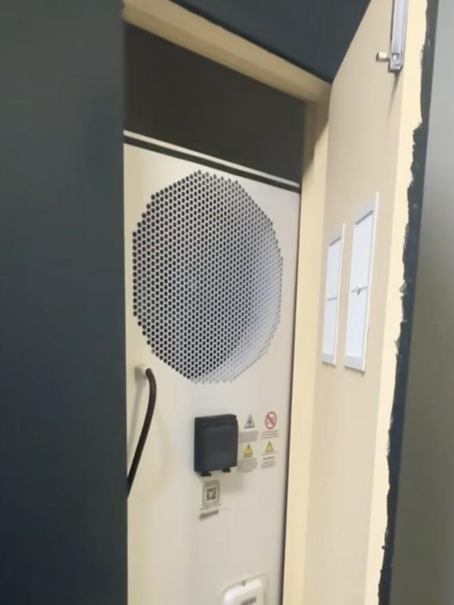 A heat pump installed inside a cupboard, - which technicians say offers very little energy savings due to the lack of open space. Picture: Supplied