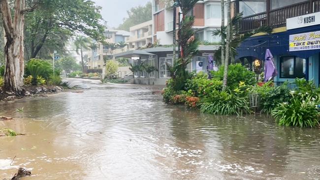 A large high tide and strong winds combined with the arrival of Tropical Cyclone Jasper in Far North Queensland to flood Williams Esplanade at Palm Cove, Cairns. Picture: Brendan Radke