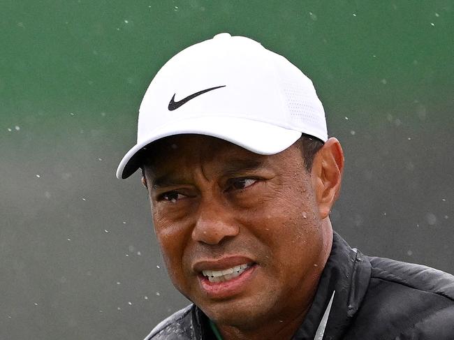 (FILES) In this file photograph taken on April 8, 2023, Tiger Woods of the US reacts on the 18th green during the continuation of the weather delayed second round of the 2023 Masters Tournament at Augusta National Golf Club in Augusta, Georgia. - Five-time winner Tiger Woods, who limped through an awful, bogey-strewn start to his rain-halted third round of the Masters, pulled out of the tournament with a foot injury organizers said on aPRIL 9, 2023. (Photo by ROSS KINNAIRD / GETTY IMAGES NORTH AMERICA / AFP)