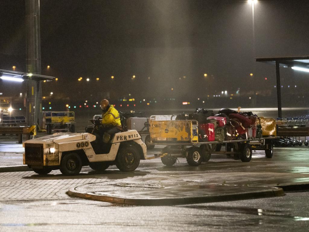 Evacuees luggage is transferred at Perth Airport on Friday morning. Picture: Matt Jelonek/Getty Images