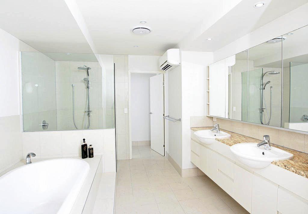 COASTAL CHIC: A bright, crisp white bathroom and ensuite is one of the features of the property at 1 Normanby St, Yeppoon soon to be auctioned. Picture: Contributed