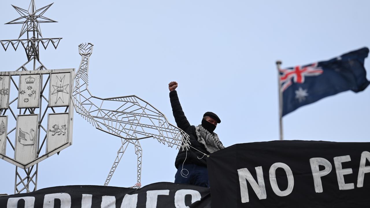 Pro-Palestine protesters have taken to the roof of Parliament House to unfurl a banner. Picture: NewsWire/ Martin Ollman