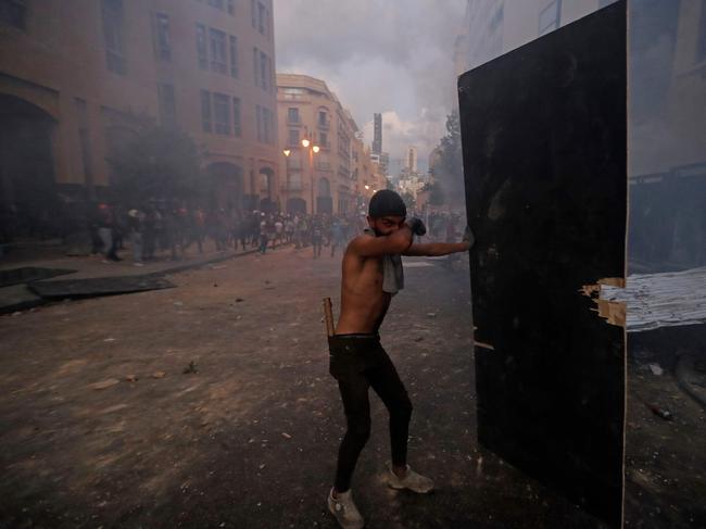 A Lebanese protester covers his face from tear gas fired by security forces in central Beirut. Picture: AFP