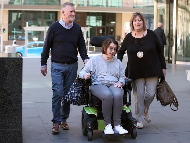 Kirby Littley and her parents Carol and Kevin leave a Royal Commission into Aged Care and Quality and Safety hearing at the Victorian County Court in Melbourne, Wednesday, September 11, 2019. A department official admits the federal government has manifestly failed to fix the problem of younger people with disabilities living in aged care. (AAP Image/David Crosling) NO ARCHIVING