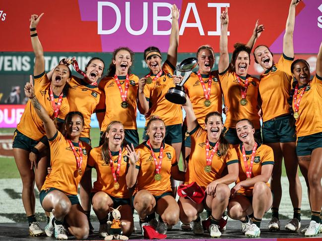 Australia's players celebrate on the podium after winning the the HSBC World Rugby Sevens Series women's final rugby match between Australia and New Zealand at the Sevens Stadium in Dubai on December 1, 2024. (Photo by FADEL SENNA / AFP)