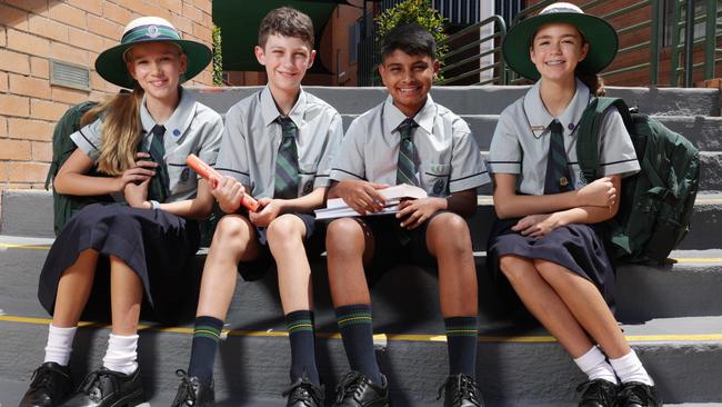 Clayfield College Year 7 students Lilly Moore, Finn Latimer, Joshua Matthew, and Elodie Whittaker were excited to return to the classroom this year as their school transitioned to a fully coeducational model. Photo: Lachie Millard