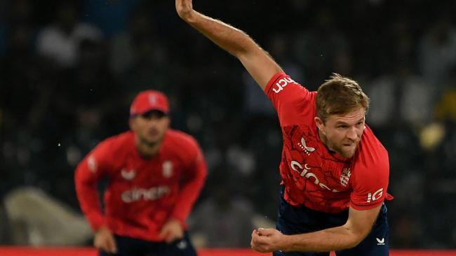 England's David Willey (R) delivers a ball during the sixth Twenty20 international cricket match between Pakistan and England at the Gaddafi Cricket Stadium in Lahore on September 30, 2022. (Photo by Aamir QURESHI / AFP)