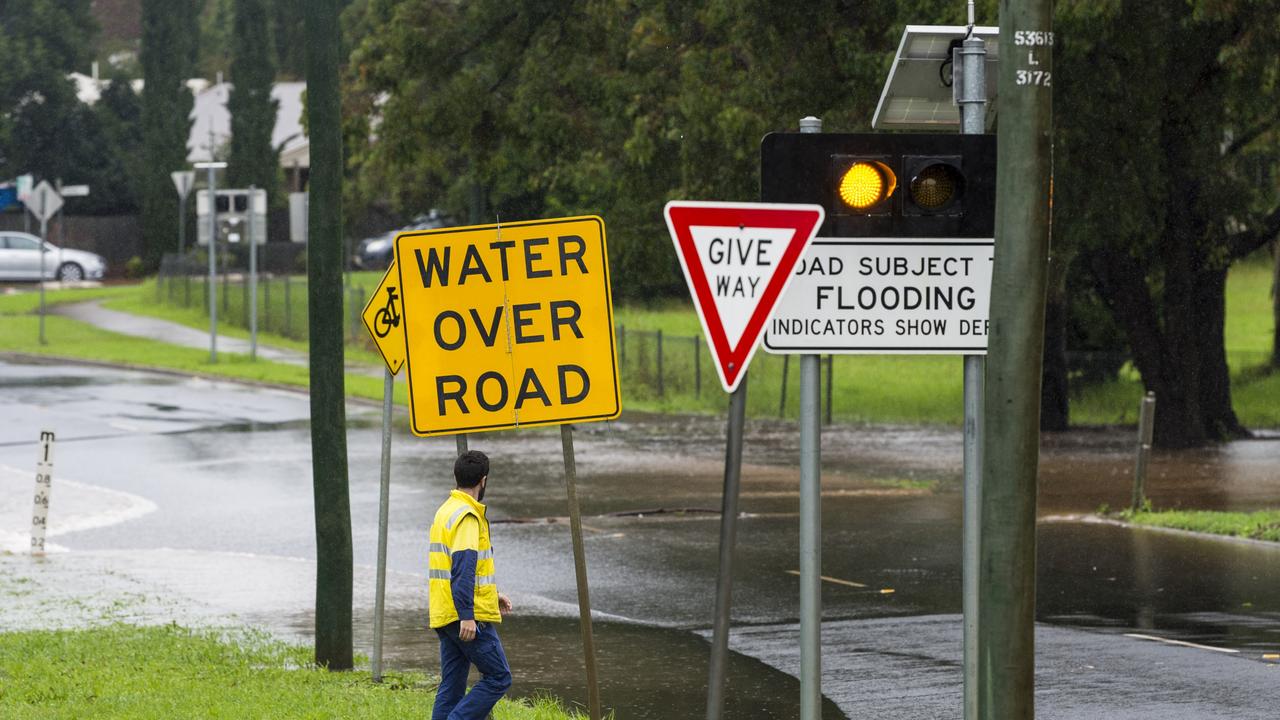 STAY ALERT: According to the Bureau of Meteorology, the heavy rain band has contracted to the eastern Darling Downs and Southeast Coast districts with the rain areas likely to contract further east later today. Water over the road closes Mackenzie Street as East Creek flows over near the South Street intersection, Tuesday, March 23, 2021. Picture: Kevin Farmer