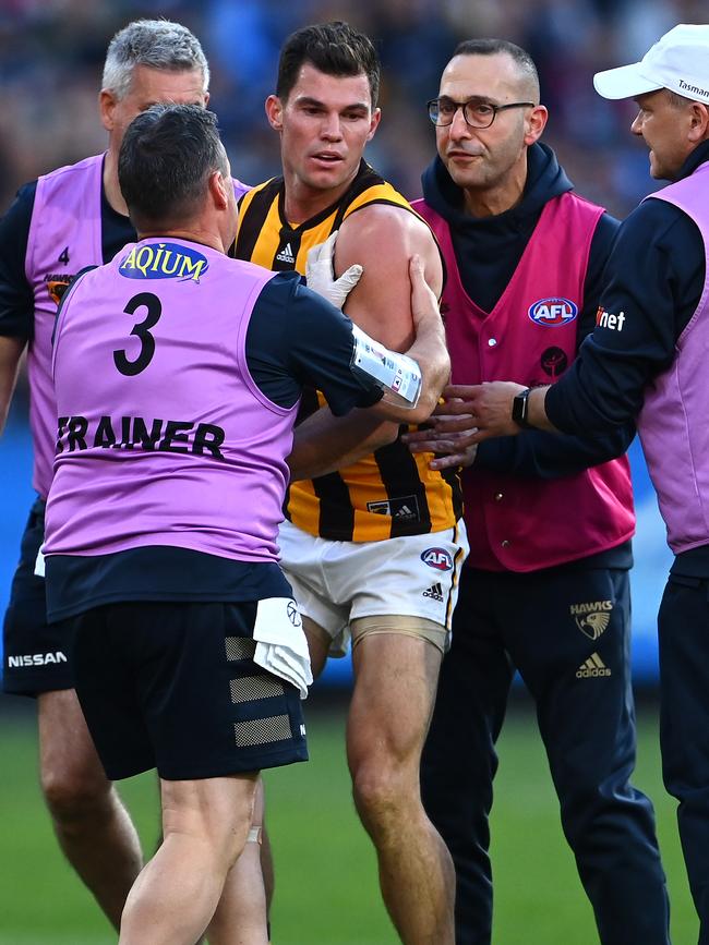 Hawthorn trainers and doctors attend to O’Meara after the clash.