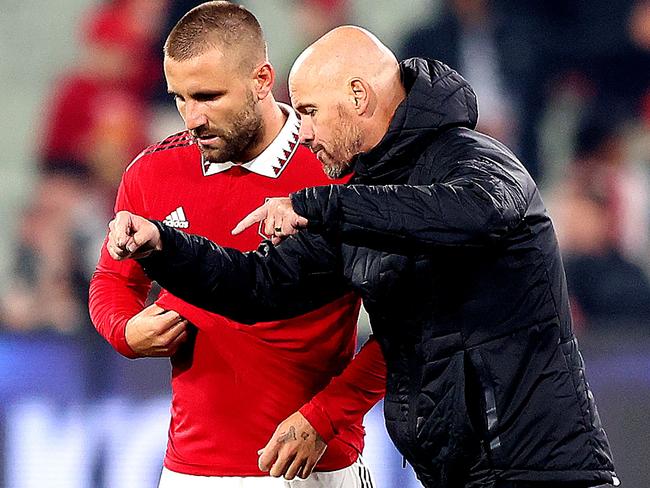 Manchester United manager Erik ten Hag speaks with Luke Shaw during a pre-season match against Melbourne Victory at the MCG. Picture: George Salpigtidis/AFP