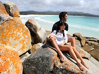 A couple relax at the Bay of Fires on the east coast of Tasmania / Chris Crerar