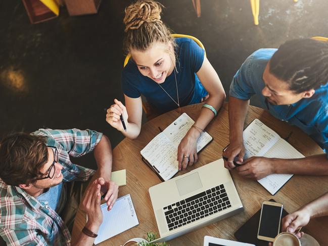 High angle shot of a group of students studying in a coffee shop