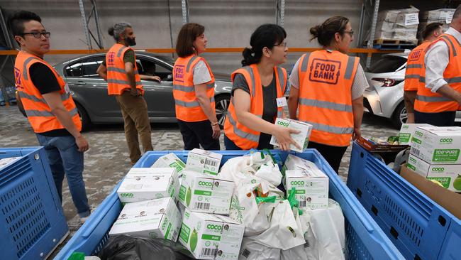 Volunteers sort food donations at Foodbank Victoria in Yarraville. Picture: Erik Anderson/AAP