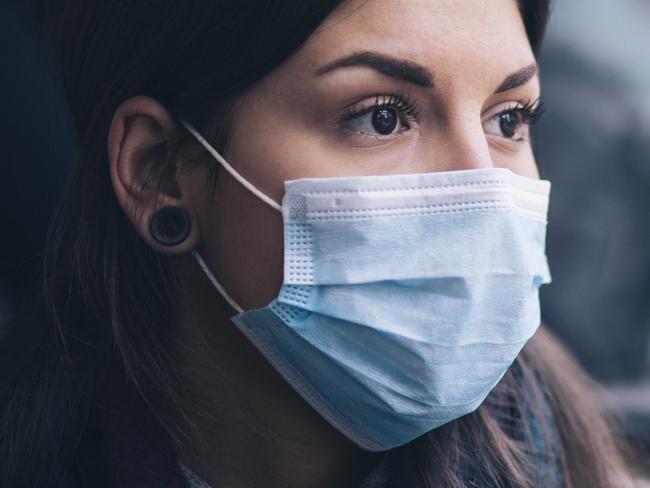 Young woman wearing protective face mask, she sitting in bus transportation in the city.