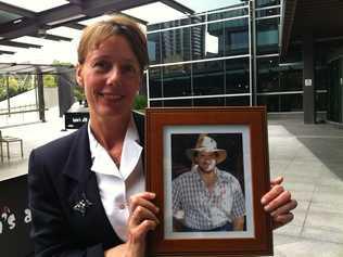 Wamuran's Andrea Mafliet, guidance officer at Woodford, with a photo of her partner Gavin Woods, who was deputy principal at Burpengary State School before taking his own life. Picture: Rae Wilson