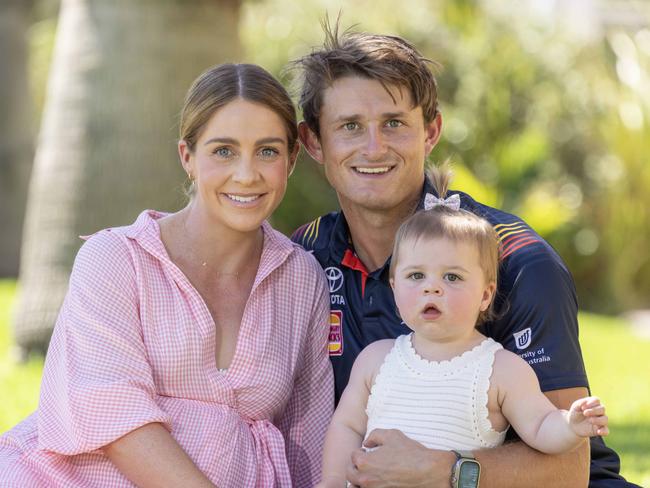 27,February, 2024:   Matt Crouch with finance Ellie Symons and daughter Ava. Matt Crouch to become Crows life member at Adelaide season launch. Picture: Kelly Barnes